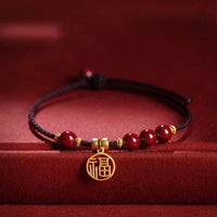Bracelet en fil tissé avec bénédiction du personnage Fu et perles de cinabre de KarmaRipple