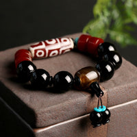 Bracelet de protection de richesse en onyx noir et perles dzi tibétaines à neuf yeux de KarmaRipple