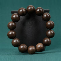 Bracelet de paix en bois d'agar flottant sur l'eau Tarakan Basic de KarmaRipple