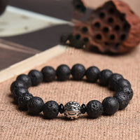 Bracelet PiXiu Wealth en perles de lave et bronze ivoire de KarmaRipple