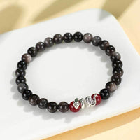 Bracelet de protection en bronze et obsidienne argentée et cinabre de KarmaRipple pour l'année du serpent