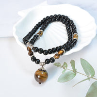 Collier pendentif renforcé en obsidienne noire et œil de tigre de KarmaRipple