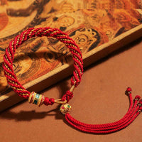 Bracelet tibétain fait main en corde tressée avec roue de prière Thangka de KarmaRipple