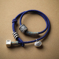 Bracelet en corde double tour sculpté tibétain Om Mani Padme Hum de KarmaRipple