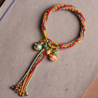 Bracelet tressé coloré en fil doré de KarmaRipple, symbole de la famille des bêtes avaleuses de fortune et de réincarnation