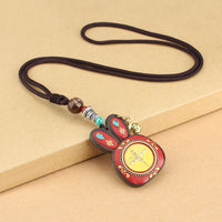 Collier pendentif Thangka en ébène du Tibet de KarmaRipple, représentant les cinq dieux de la richesse