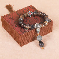 Bracelet de sagesse en perles de verre gravées Dorje Vajra avec roue de prière tibétaine Om Mani Padme Hum de KarmaRipple