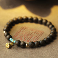 Bracelet de force en bois d'agar et lotus de KarmaRipple